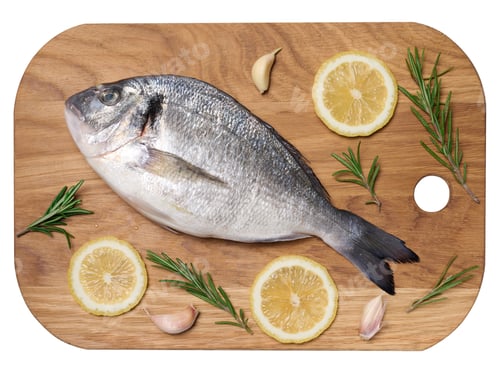 Preview: Raw whole dorado fish on wooden kitchen board and spices for cooking, top view