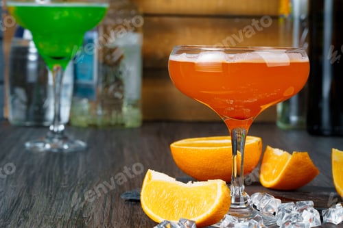 Preview: Two beautiful cocktails served on a wooden bar counter