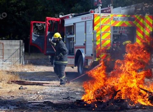 Preview: He lives for this. Shot of a firefighter preparing to put out a fire.