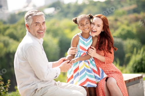 Preview: Cheerful husband and wife feeling happy after adopting girl