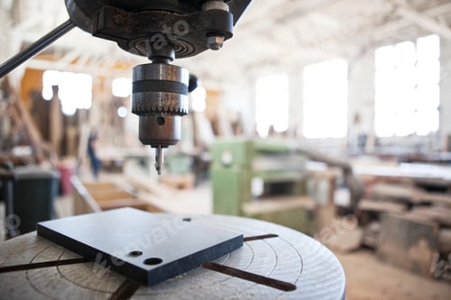 Preview: Close up view of a drill press in a woodworking factory.