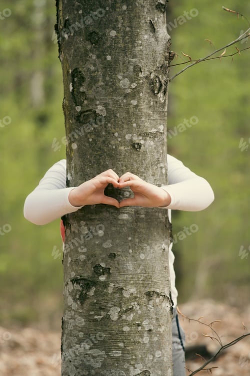 Preview: Young generation embracing nature, with a hug at a tree