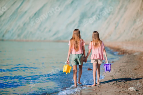 Preview: Adorable little girls having fun on the beach