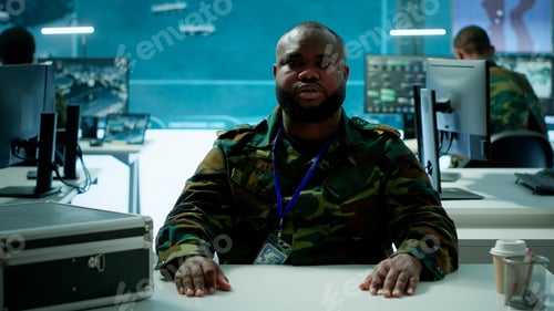 Preview: Reconnaissance expert engages in a online videocall in a high tech control room