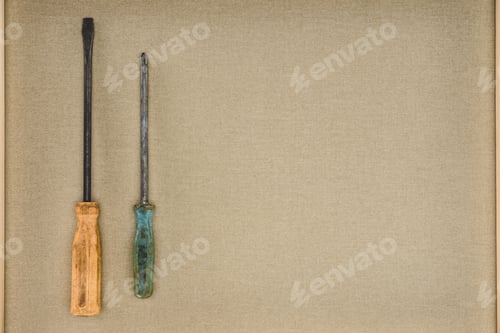 Preview: top view of two different screwdrivers on beige background
