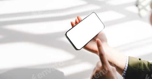 Preview: Typing on a smartphone Working online on laptop, computer and smartphone on white table at office. F