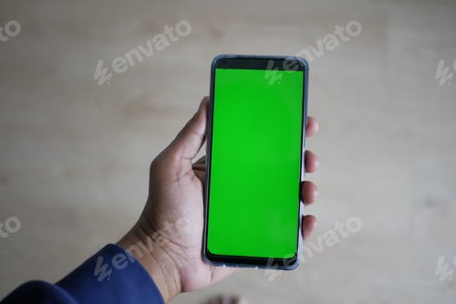 Preview: Close up of young man hand using smart phone with green screen