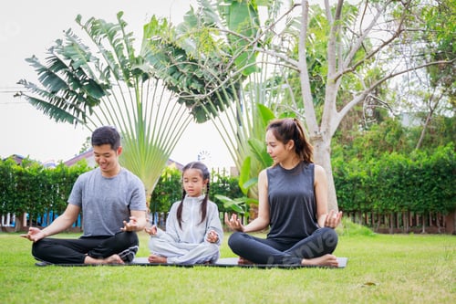 Preview: Family Asian parent and child daughter are preparing to play yoga together at home garden.