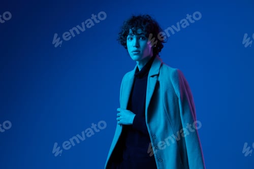Preview: Man fashion in coat on dark blue background, neon light, style and trends, mixed light, men's
