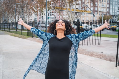 Preview: Afro american woman with arms raised.