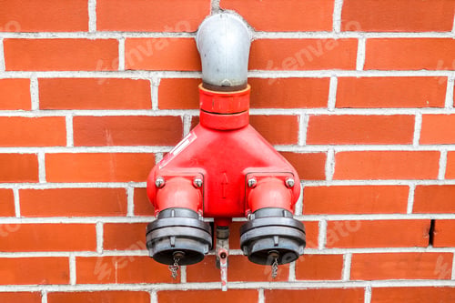 Preview: Closeup of an emergency fire water supply outlet on a brick wall