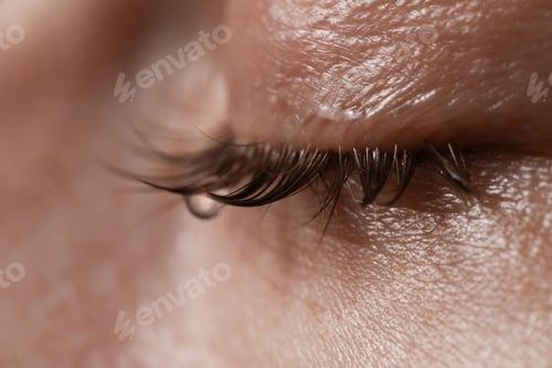 Preview: Closeup view of sad young woman crying
