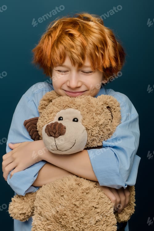 Preview: Little boy embraces his soft teddy bear with pure joy and happiness in a cozy setting