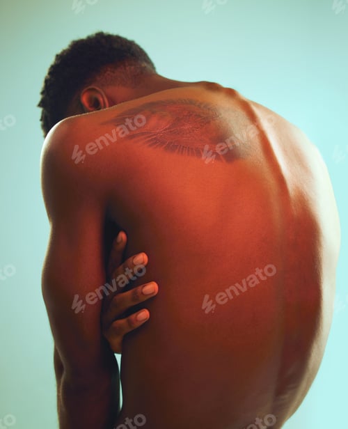 Preview: Rearview shot of a man posing shirtless against a blue background