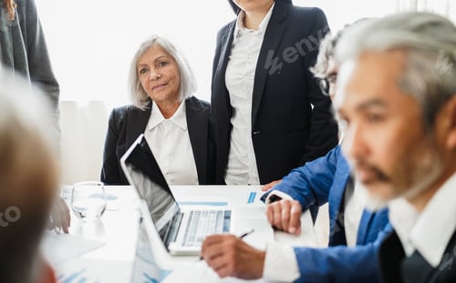 Preview: Multigenerational business people working inside corporate office
