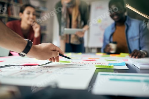 Preview: Close-up of creative business team working on new strategy during the meeting.