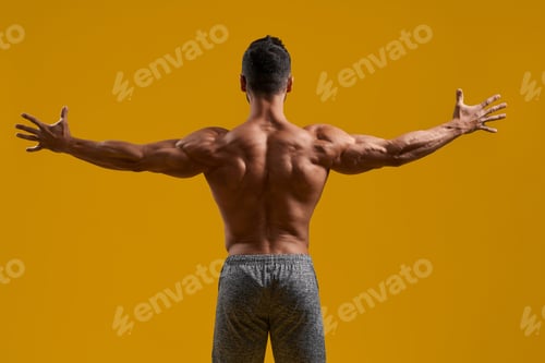 Preview: Athletic gentleman posing on yellow background
