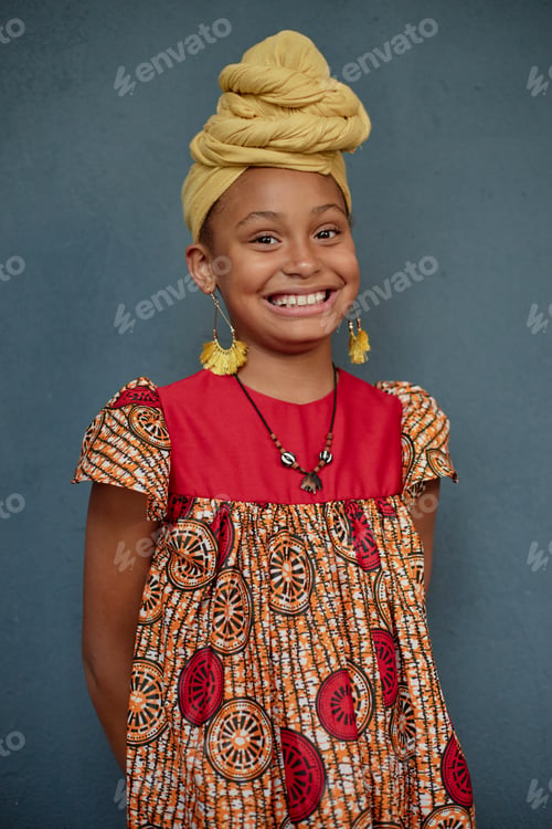 Preview: Portrait of Smiling Black Girl Celebrating Kwanzaa Against Blue Background