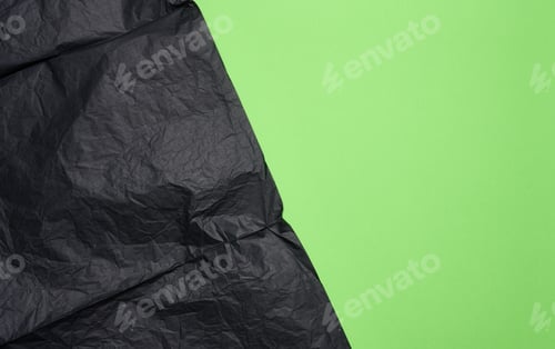 Preview: Crumpled sheet of black parchment paper, green background