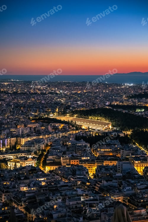 Preview: illuminated skyline of Athens, Greece, with Panathenaic stadium in Athens, Greece during sunset.