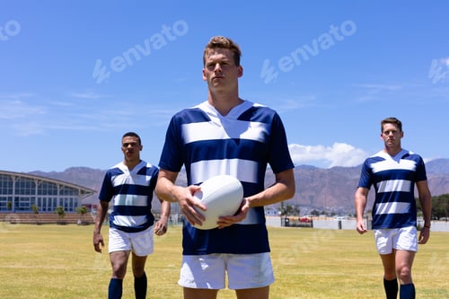 Preview: Rugbymen standing with ball