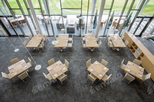 Preview: Overview of two rows of tables served for guests in large luxurious restaurant