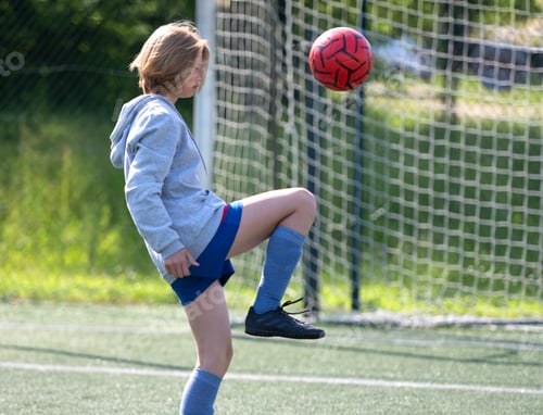 Preview: Child Kicks Ball With Foot In Close-Up