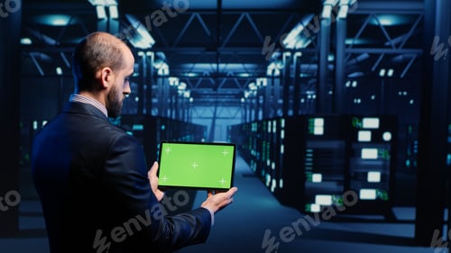 Preview: System engineer checking green screen display on tablet