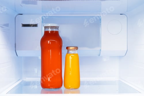 Preview: Glass bottle of juice on a fridge shelf