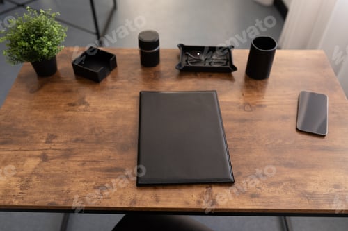 Preview: desktop in the office with a leather folder on a wooden surface