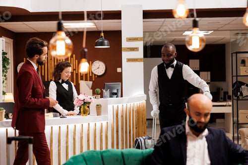 Preview: Bellboy assisting businessman