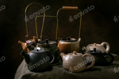 Preview: Set of craft handmade ceramic teapots with dark background