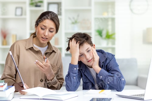 Preview: Cute and boring study at home, mom explains homework to son, family study at home sitting in living
