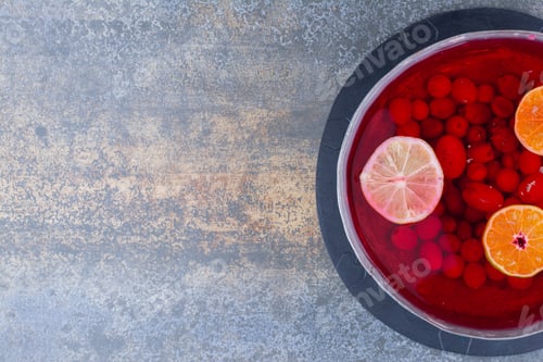 Preview: A dark pan of red juice on marble background