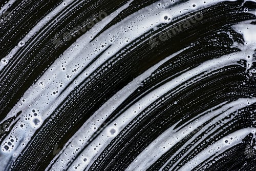 Preview: texture of white soap foam on black surface