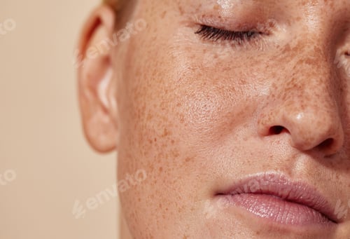 Preview: Cropped shot of the face of a young woman with freckles