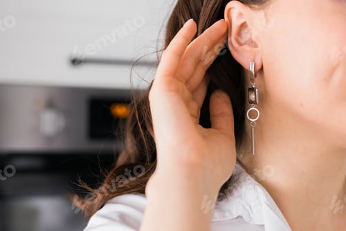Preview: Jewelry and close-up earrings in a beautiful female ear - women's accessories, silver trendy