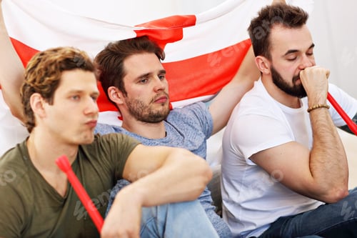Preview: Happy male friends cheering and watching sports on tv