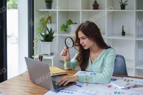 Preview: accountant holding a magnifying glass and using a calculator to check financial statements