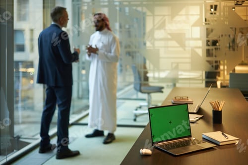 Preview: Laptop with Chroma Key Screen in Modern Office With Businessmen in Background
