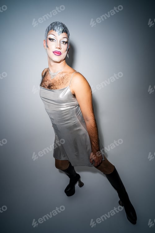 Preview: Latin Drag Queen Poses in Direct Flash Studio Portrait With Confident Expression and Striking Outfit