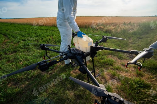Preview: Drone operator, modern farmer with drone on agricultural fields