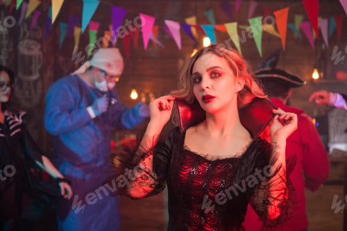 Preview: Portrait of sexy woman dressed up in a witch costume at halloween event