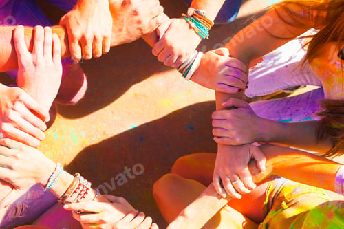 Preview: Friends putting their hands together in a sign of unity and teamwork