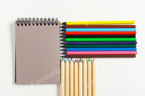 Preview: colored pencils and notepad on the table