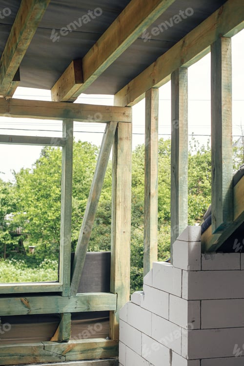 Preview: Unfinished attic wooden roof framing with vapor barrier, dormer and windows