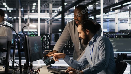 Preview: Data center engineers use laptop, collaborating on doing AI software updates