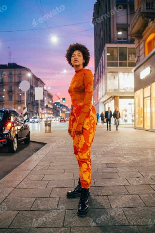 Preview: Stylish confident black curly hair woman posing outdoor cool attitude