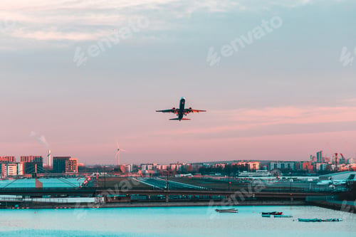 Preview: Airplane taking off from London city airport at sunset