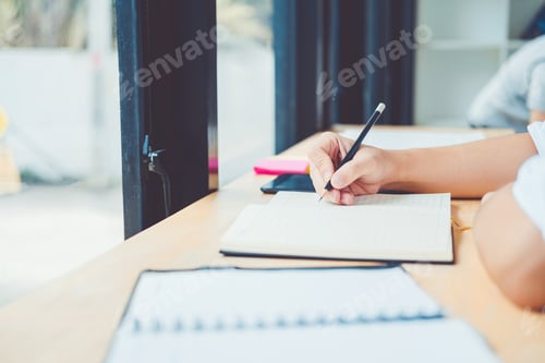 Preview: High school or college students studying and reading together in library